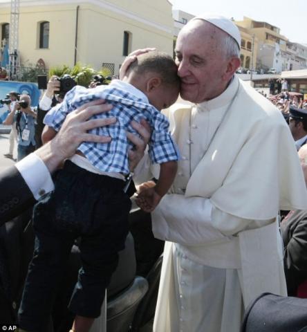 Pope kisses child at Lampudesa