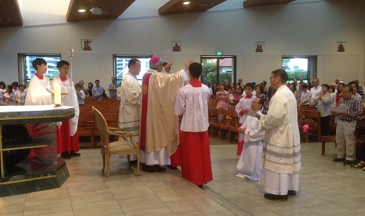 Singapore Archbishop William Goh ordaining Matthew Tan SJ to the diaconate.