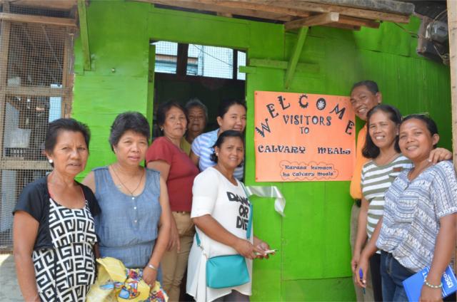 Members of the Calvary Hills BEC Homebased Workers Association smile in front of their mini eatery, Calvary Meals, after its blessing last March.