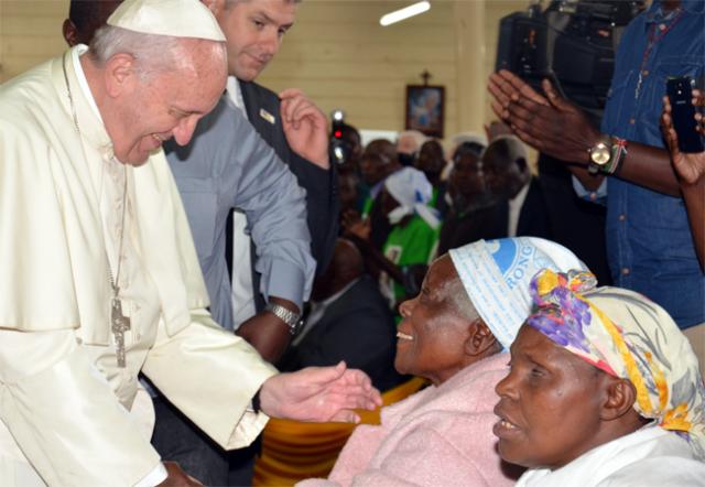 Pope Francis greets a woman at St. Joseph the Worker Church.