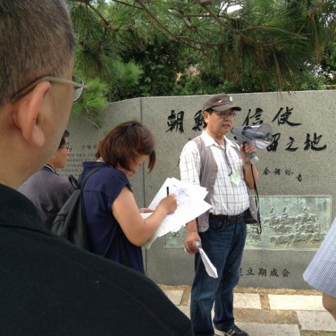 At a monument remembering Korean workers brought to Shimonoseki who died during World War II