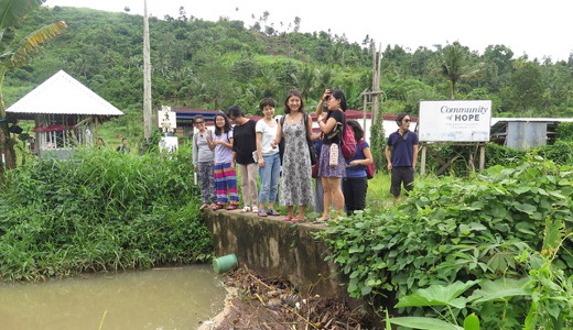 Students learn about disaster risk reduction and management during their field visit to areas hit by Typhoon Haiyan
